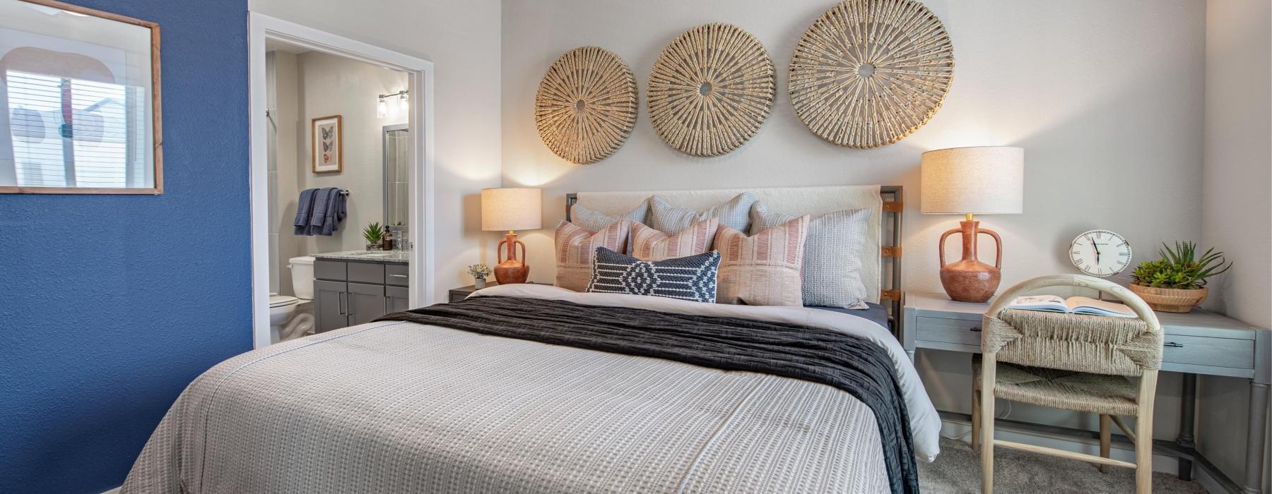 a bedroom with a bed and lamps