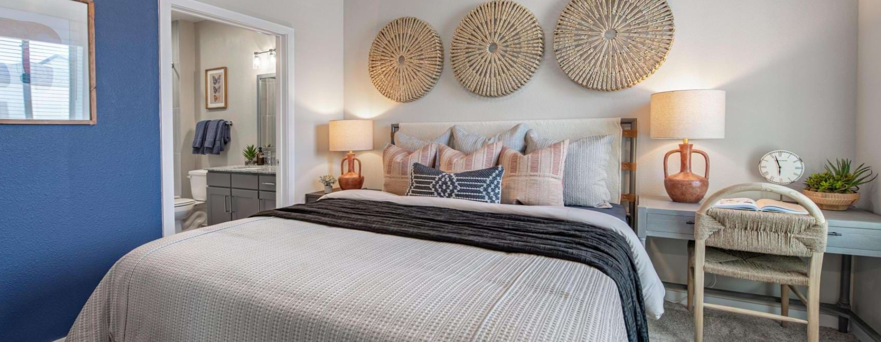a bedroom with a bed and lamps