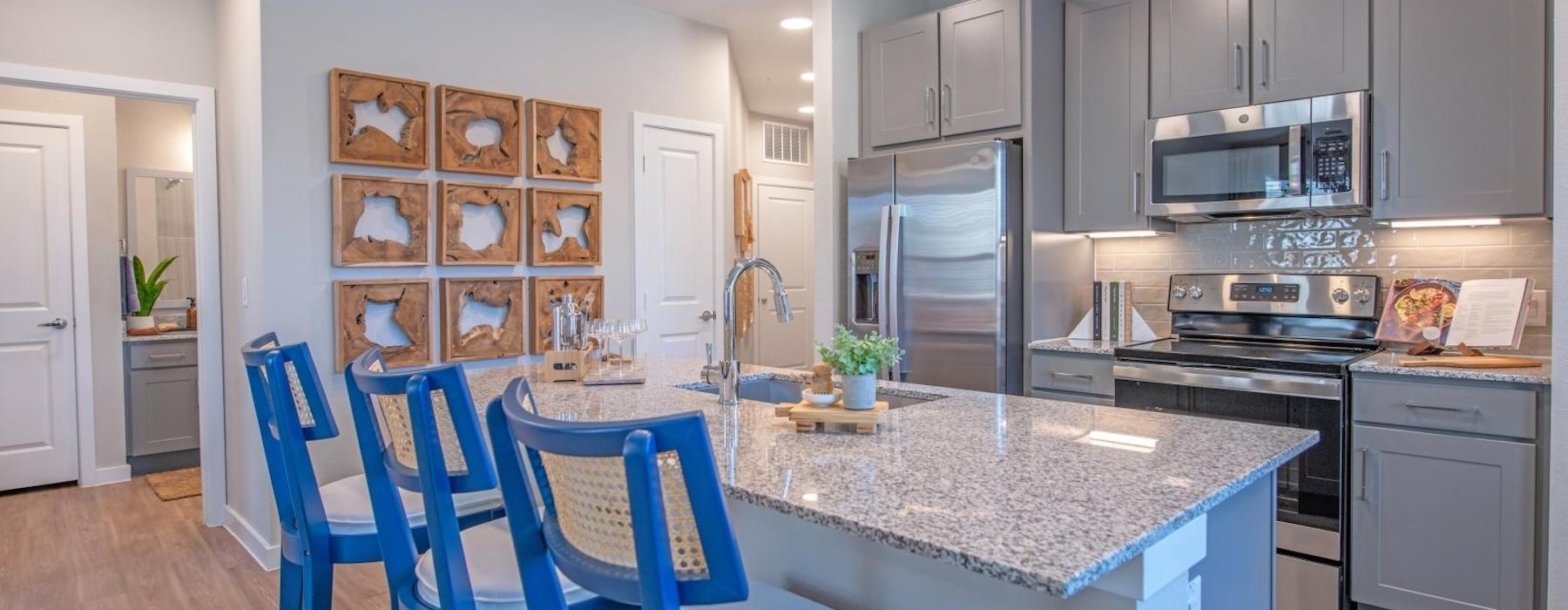 a kitchen with an island and chairs
