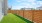 a fenced in yard with houses in the background