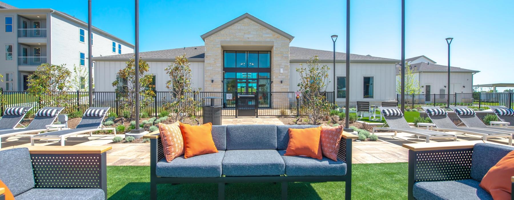 a group of chairs and a couch in a grassy area